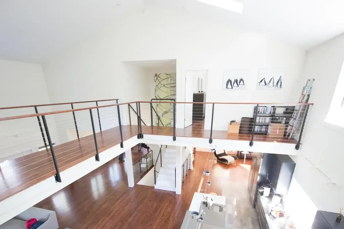 An aerial view of a house with a balcony and stairs