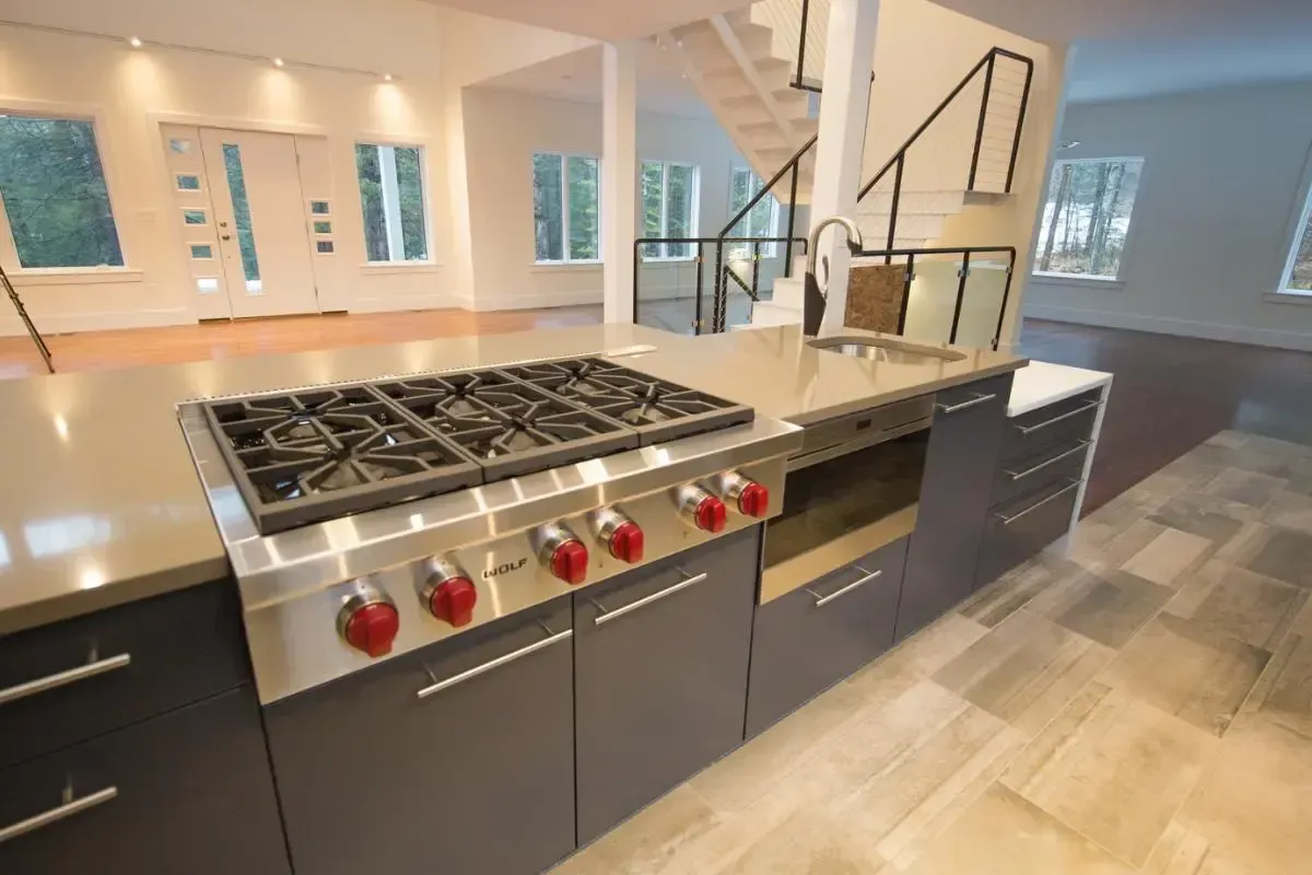 A kitchen with a stove top oven and a sink.
