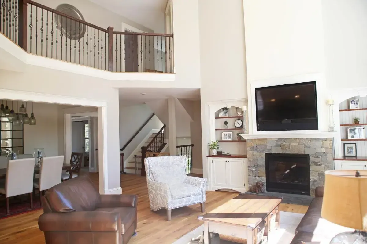 A living room with a fireplace and a flat screen tv