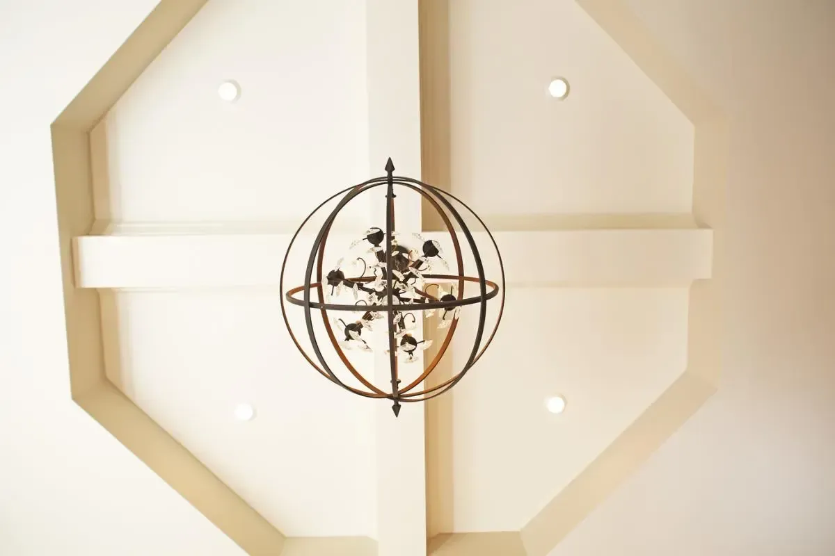 A chandelier is hanging from the ceiling of a room.