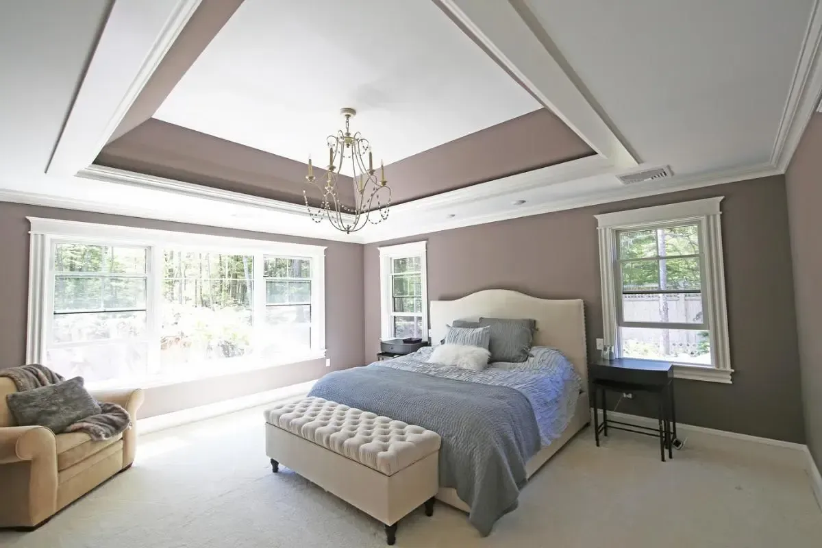 A bedroom with a large bed and a couch