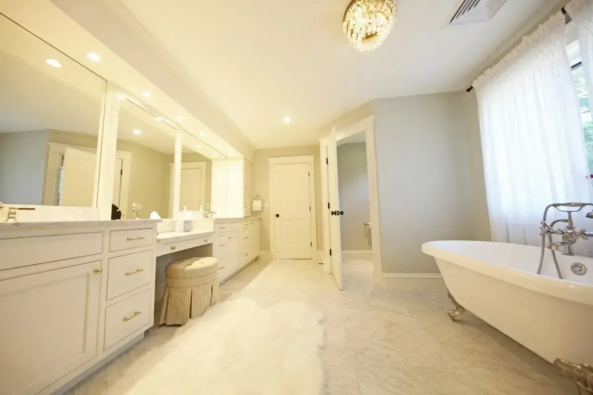A bathroom with a claw foot tub and two sinks