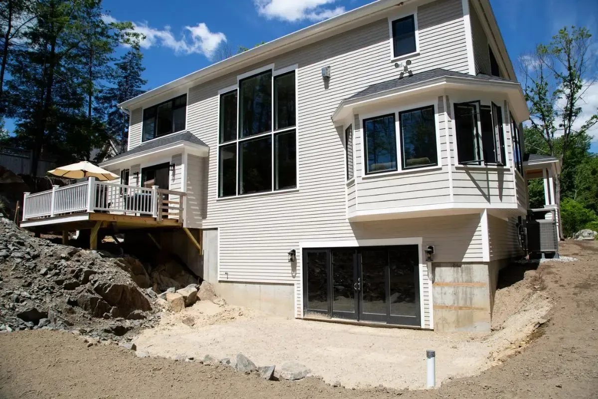 A large white house with a lot of windows and a large deck