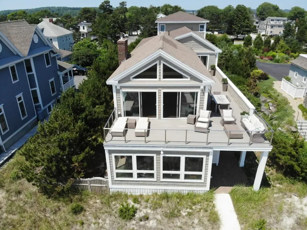 An aerial view of a large house with a large deck