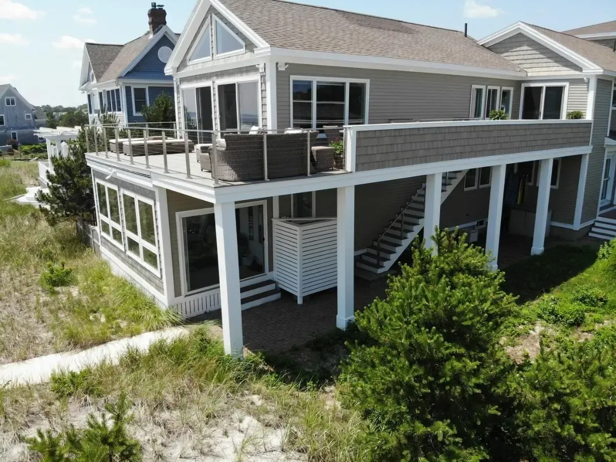 An aerial view of a large house with a balcony and stairs.