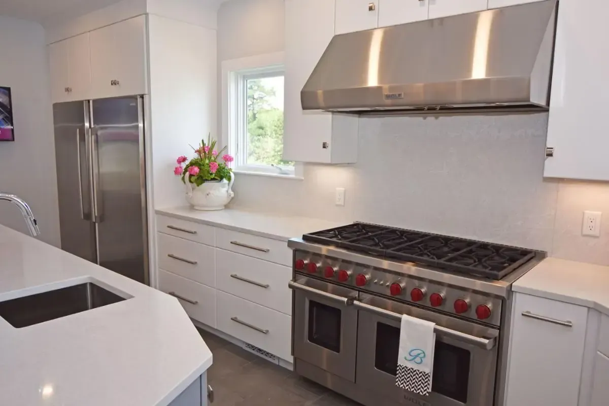 A kitchen with stainless steel appliances and white cabinets