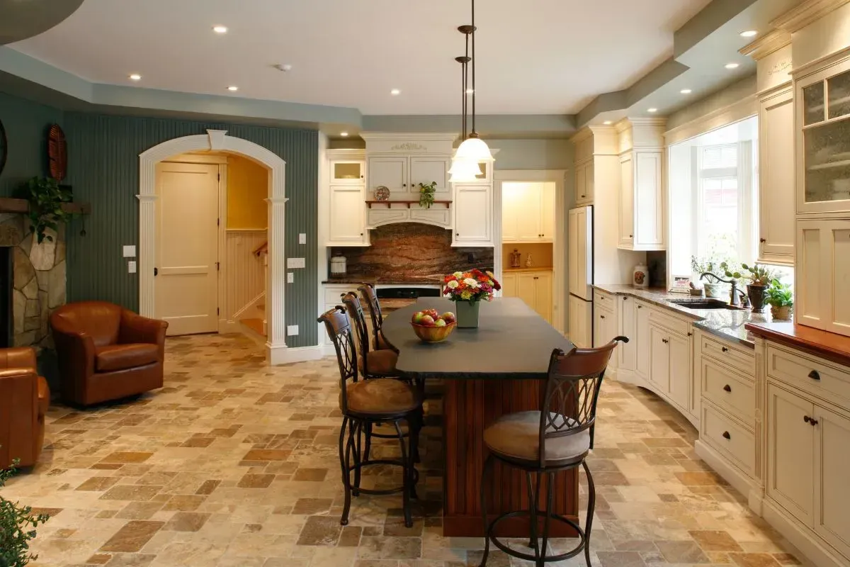A kitchen with white cabinets and a large island