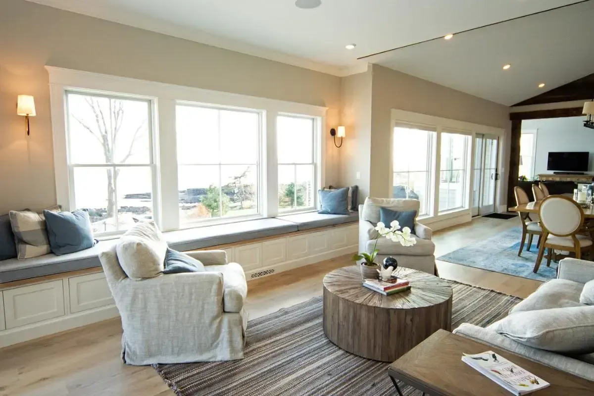 A living room with a lot of windows and furniture.