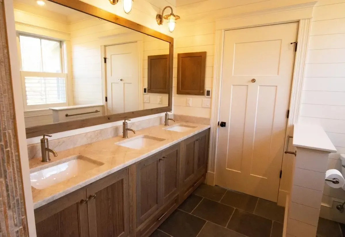 A bathroom with two sinks and two mirrors.