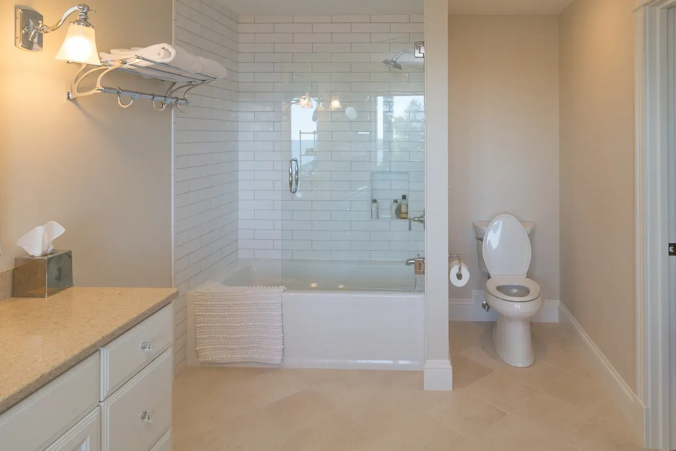 A bathroom with a toilet , bathtub and shower.