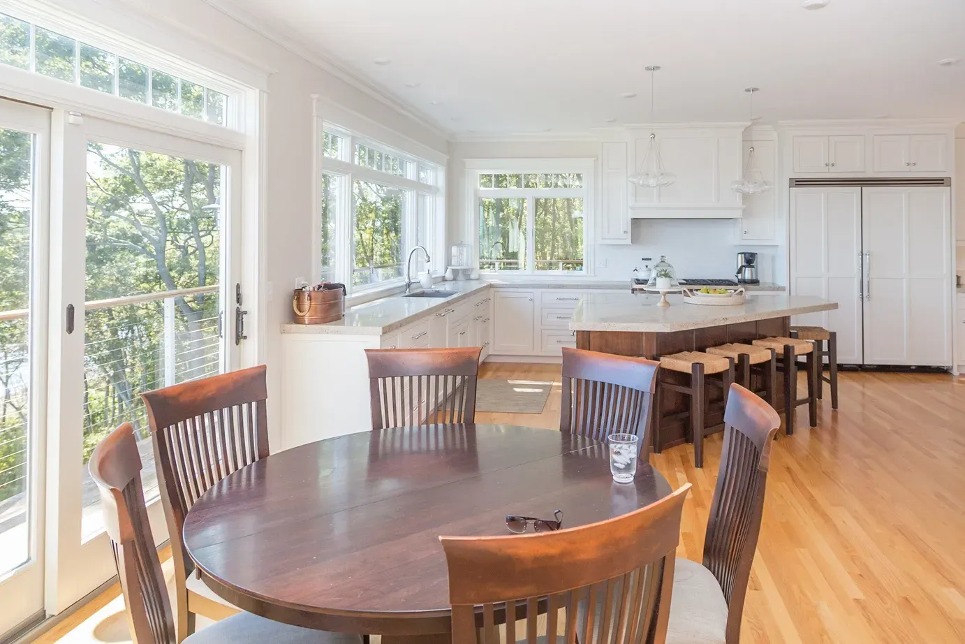 A kitchen with a round table and chairs and a large island.