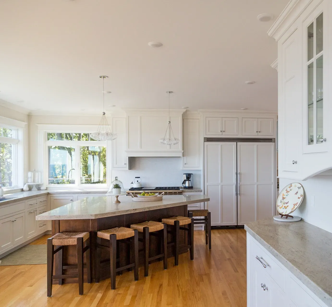 A kitchen with a large island and stools
