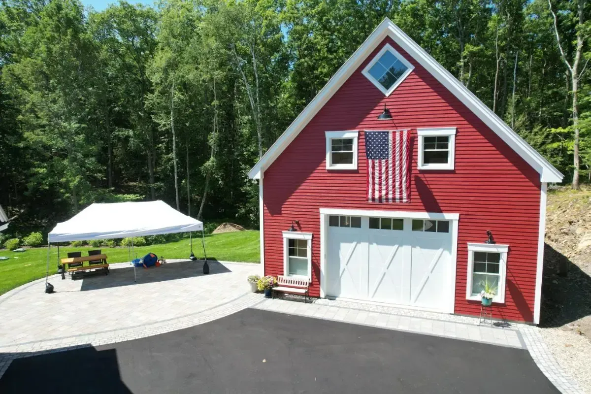 A red barn with an american flag on top of it
