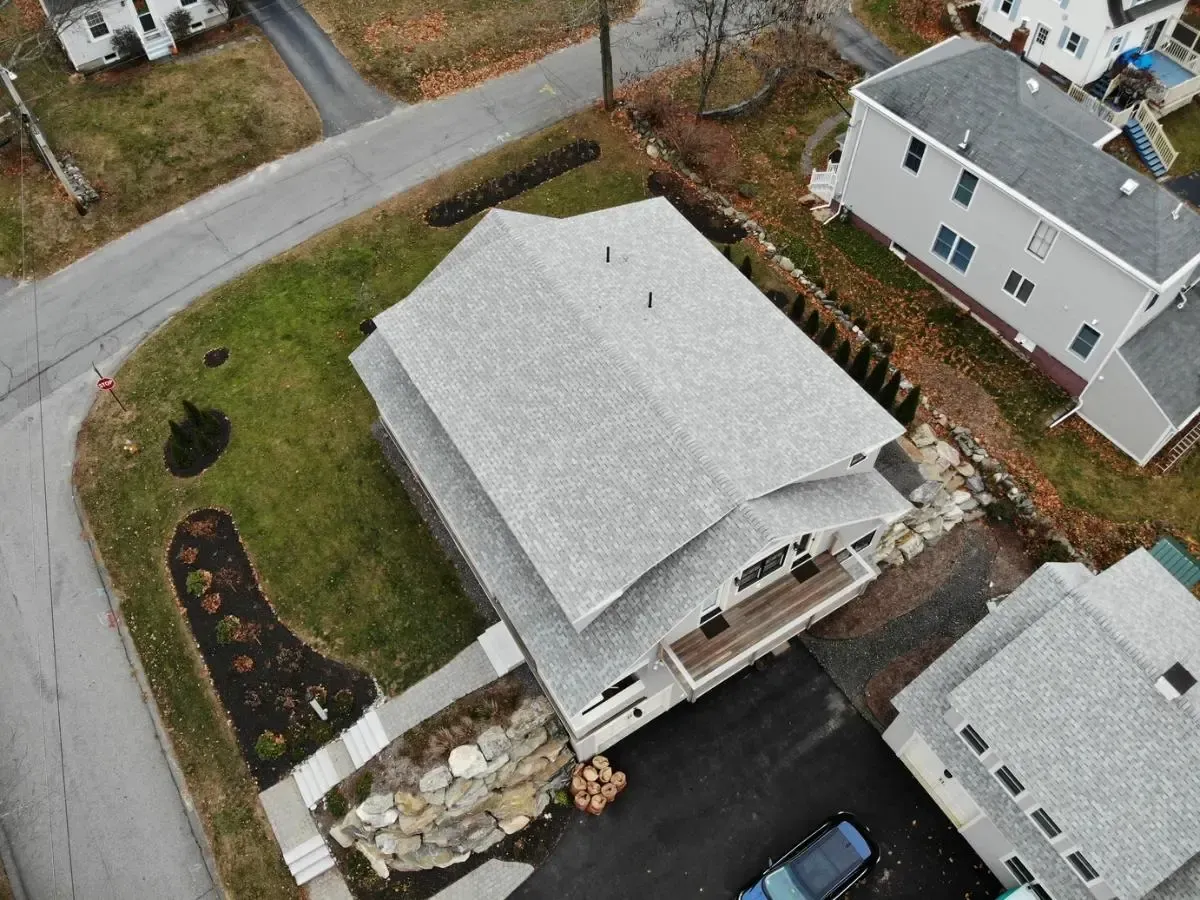 An aerial view of a house with a gray roof