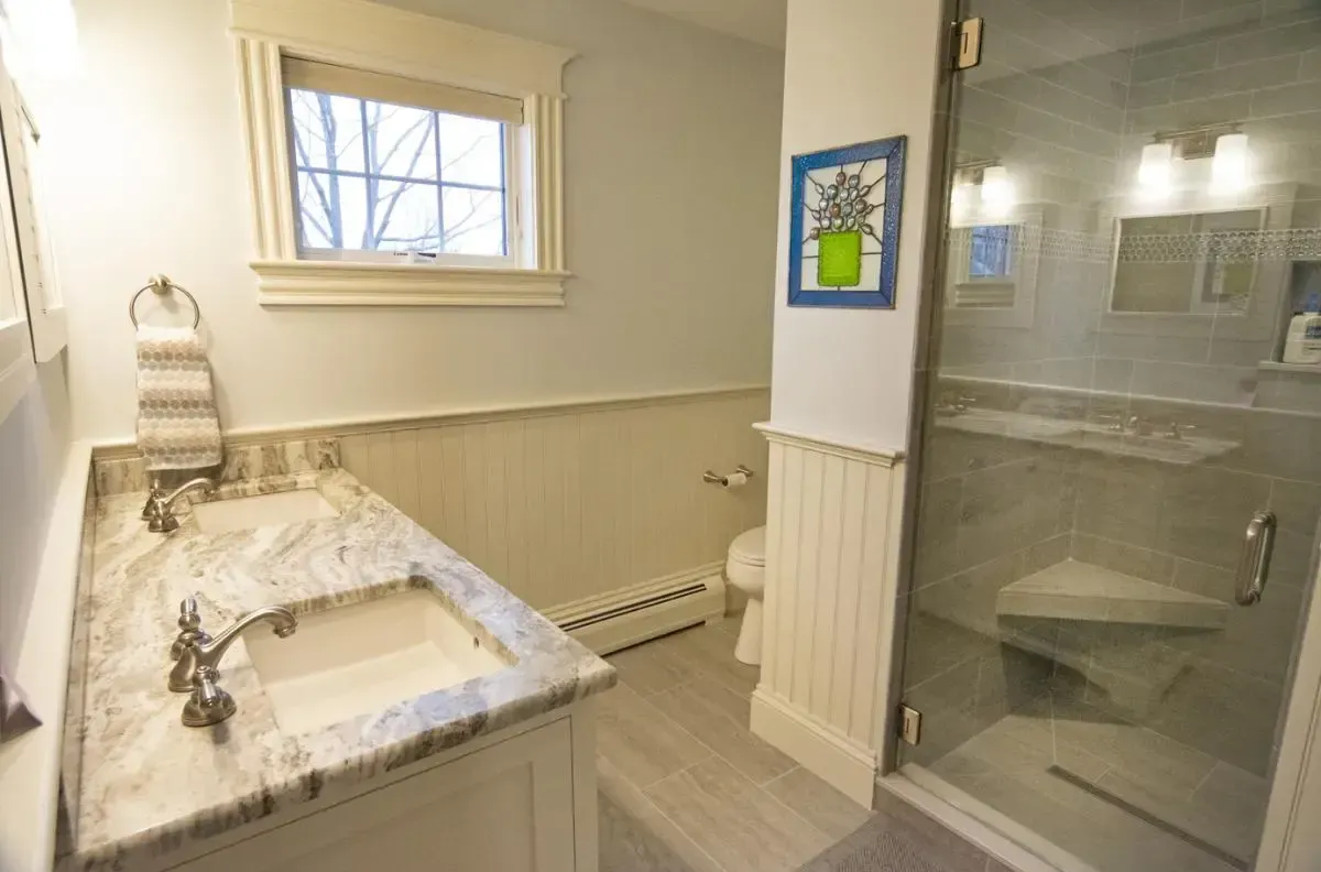 A bathroom with a sink , toilet , and shower.