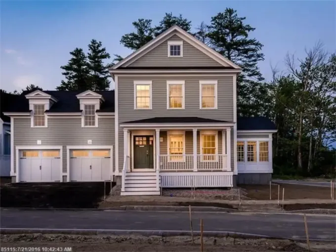 A large house with two garages and a porch