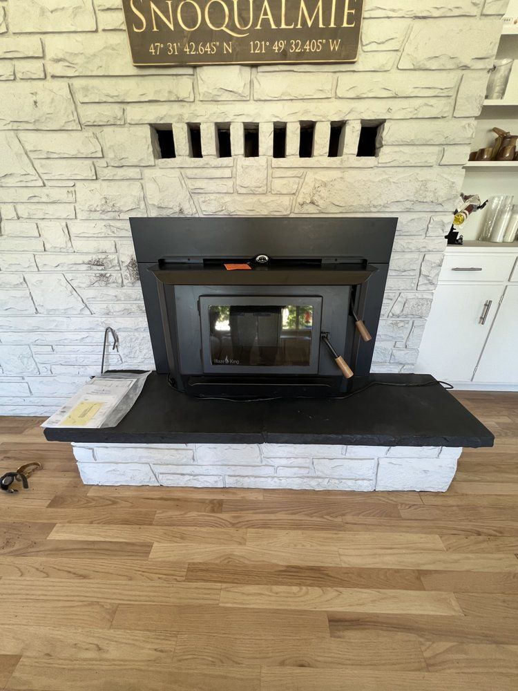 A fireplace with a sign above it in a living room.