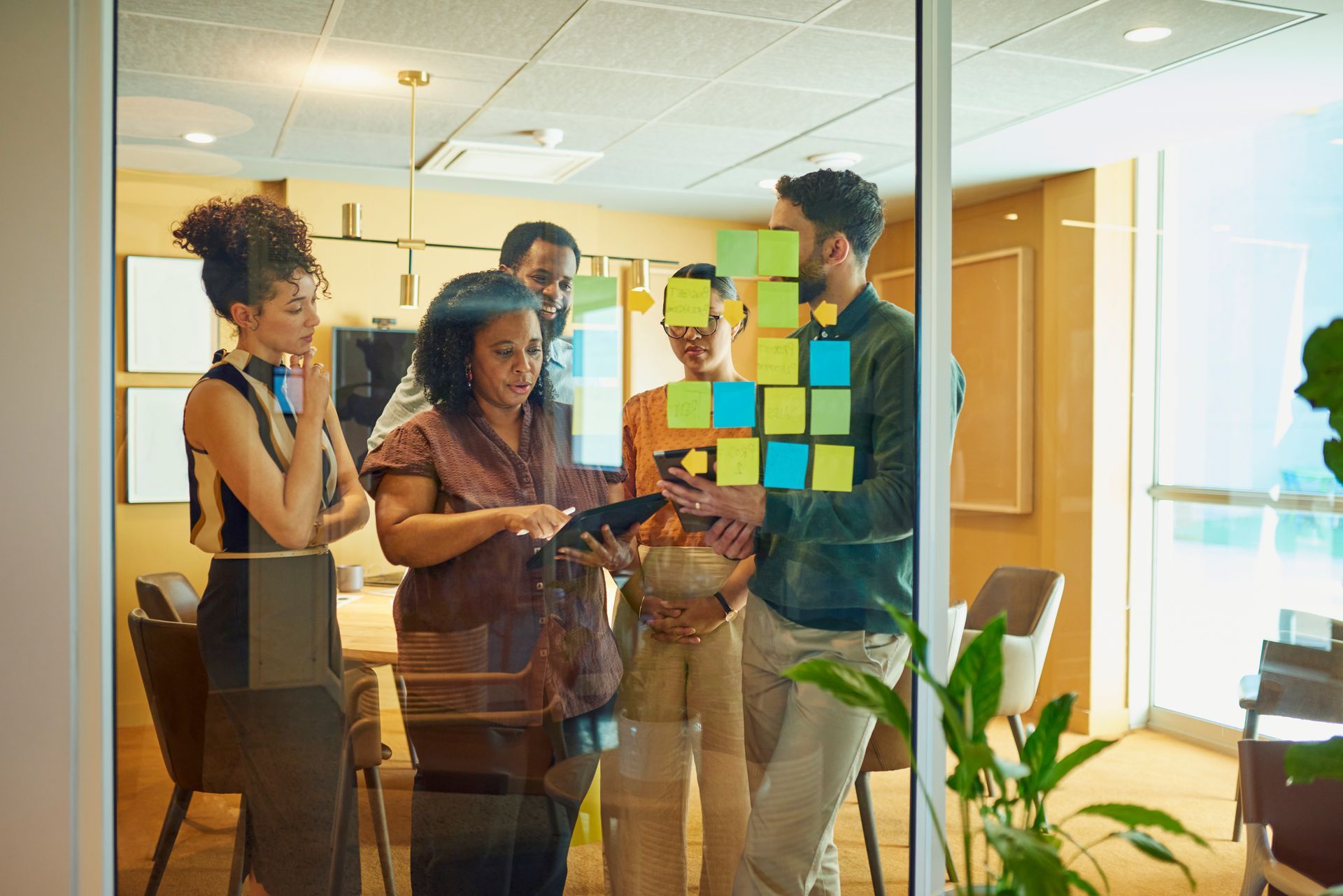 Group of diverse employees brainstorming over the last quarter of the year changes and improvements.