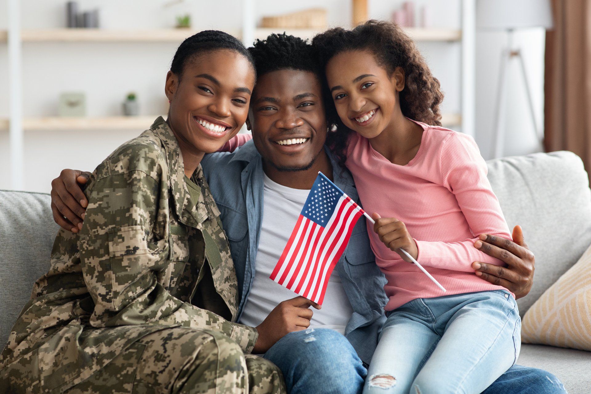 Beautiful black family celebrating a military reunion at home