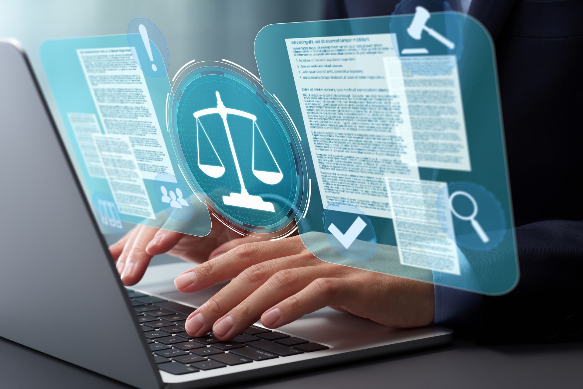 A person is typing on a laptop computer with a scale of justice coming out of the screen.
