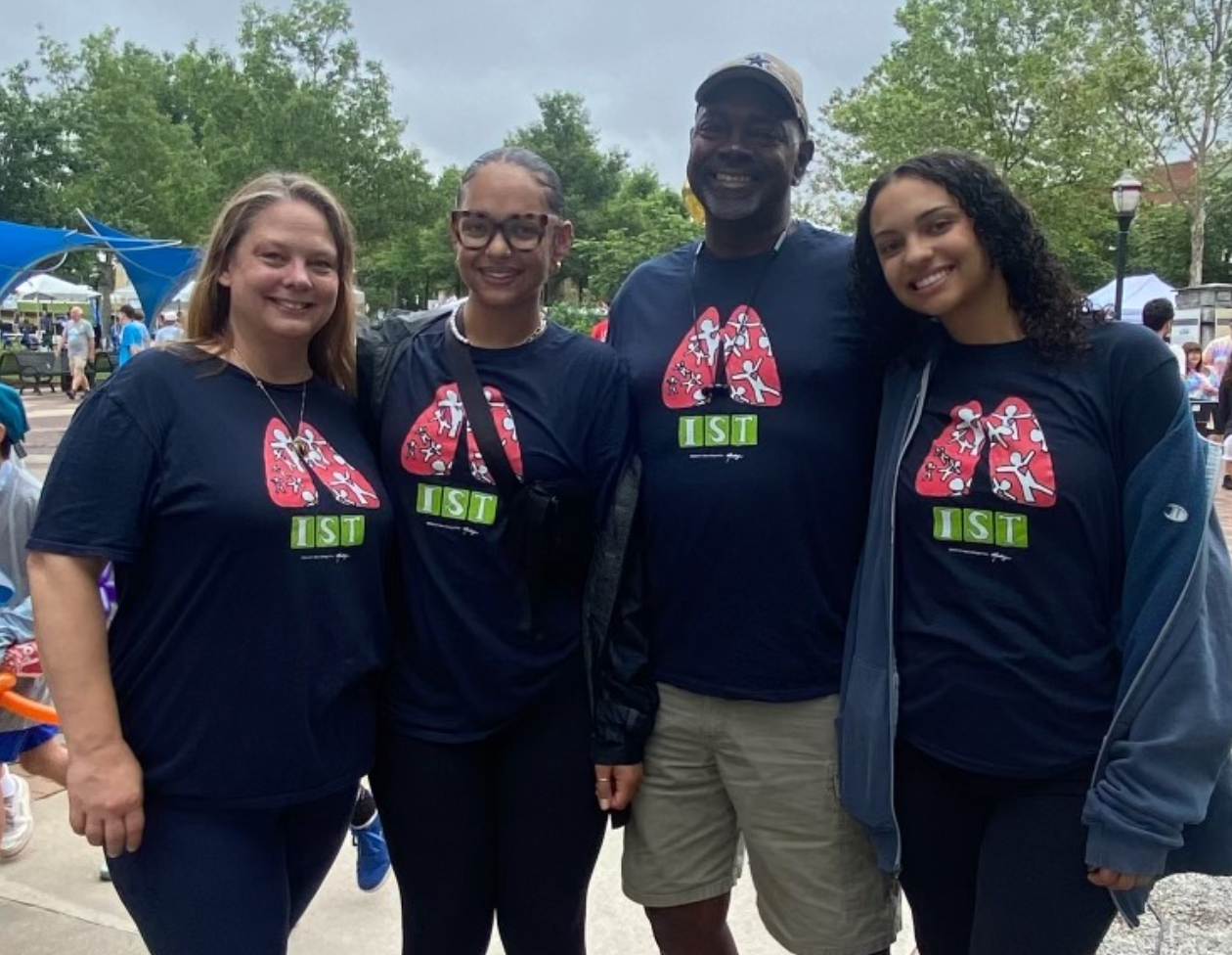 Lori Mitchum (L) Vice President of Human Resources Administration & her family, volunteering.