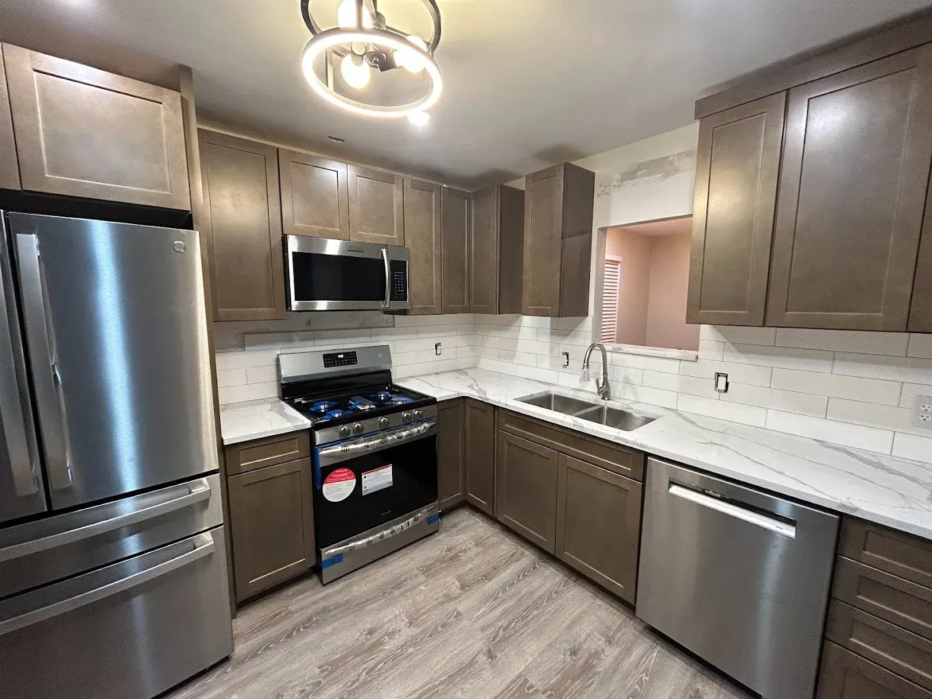 A kitchen with stainless steel appliances and wooden cabinets.