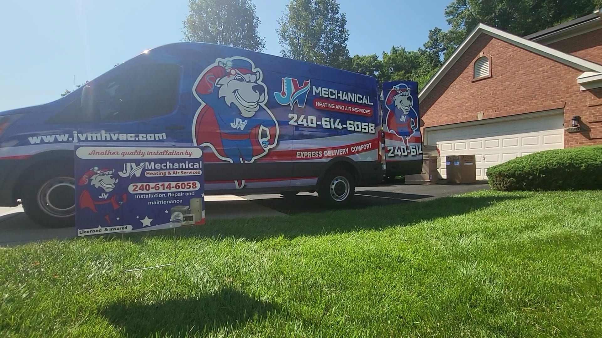 A blue JN Mechanical service van parked in a driveway in front of a brick house with a matching yard sign in the grass.