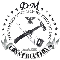 Construction company logo with crossed hammer and saw, eagle symbol, and text "DM Construction Co."