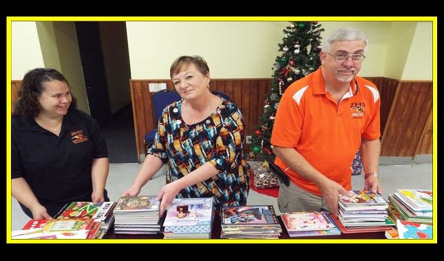 A man in an orange shirt with the letter t on it
