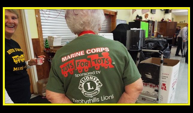 A woman wearing a t-shirt that says marine corps toys for tots