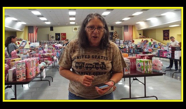 A woman wearing a united states t-shirt is standing in a store