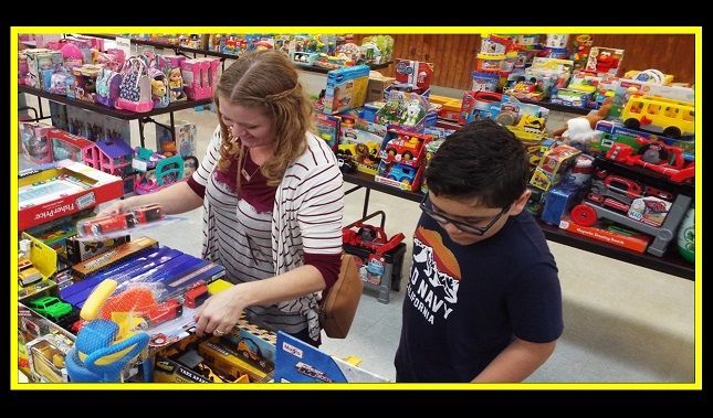 A boy and a girl are looking at toys in a store.