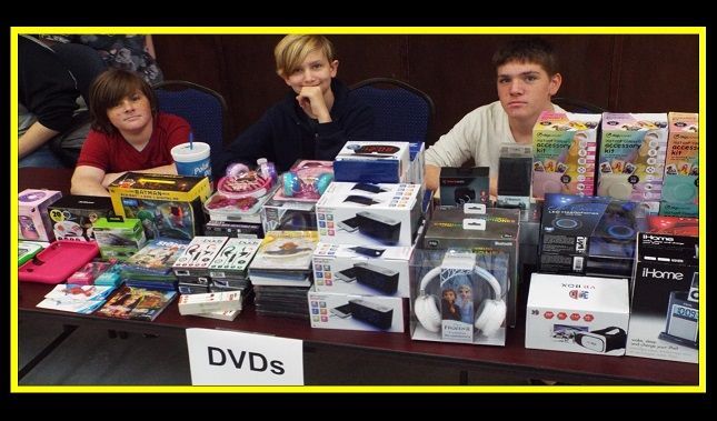 A table with a sign that says dvds on it