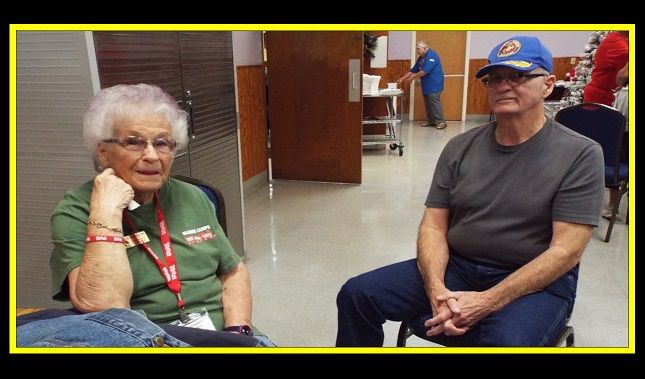 A man and a woman are sitting next to each other in a room.