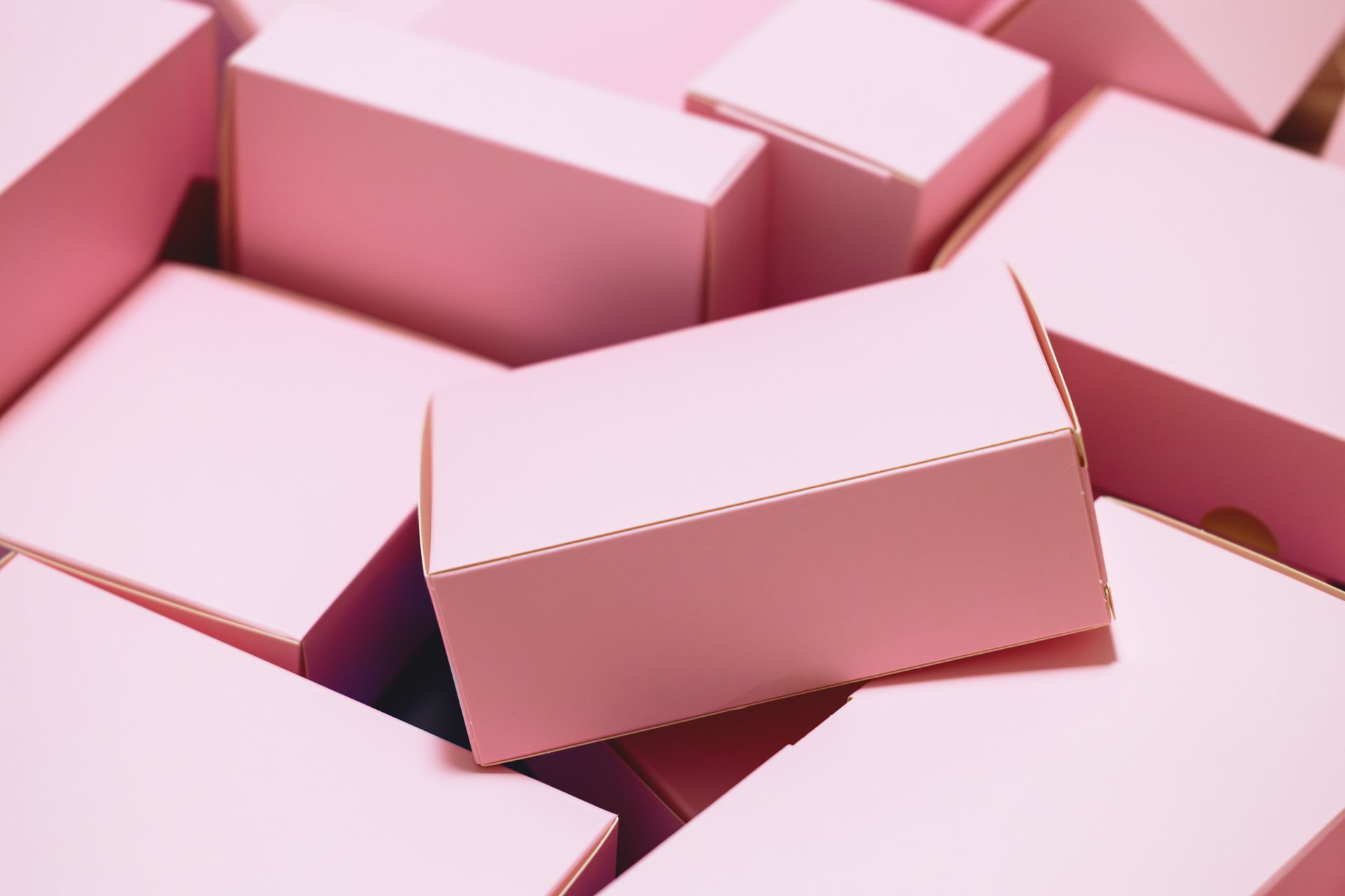Pink cardboard boxes piled together, various sizes and shapes, decorative packaging. Pink cardboard boxes piled together, various sizes and shapes, decorative packaging.