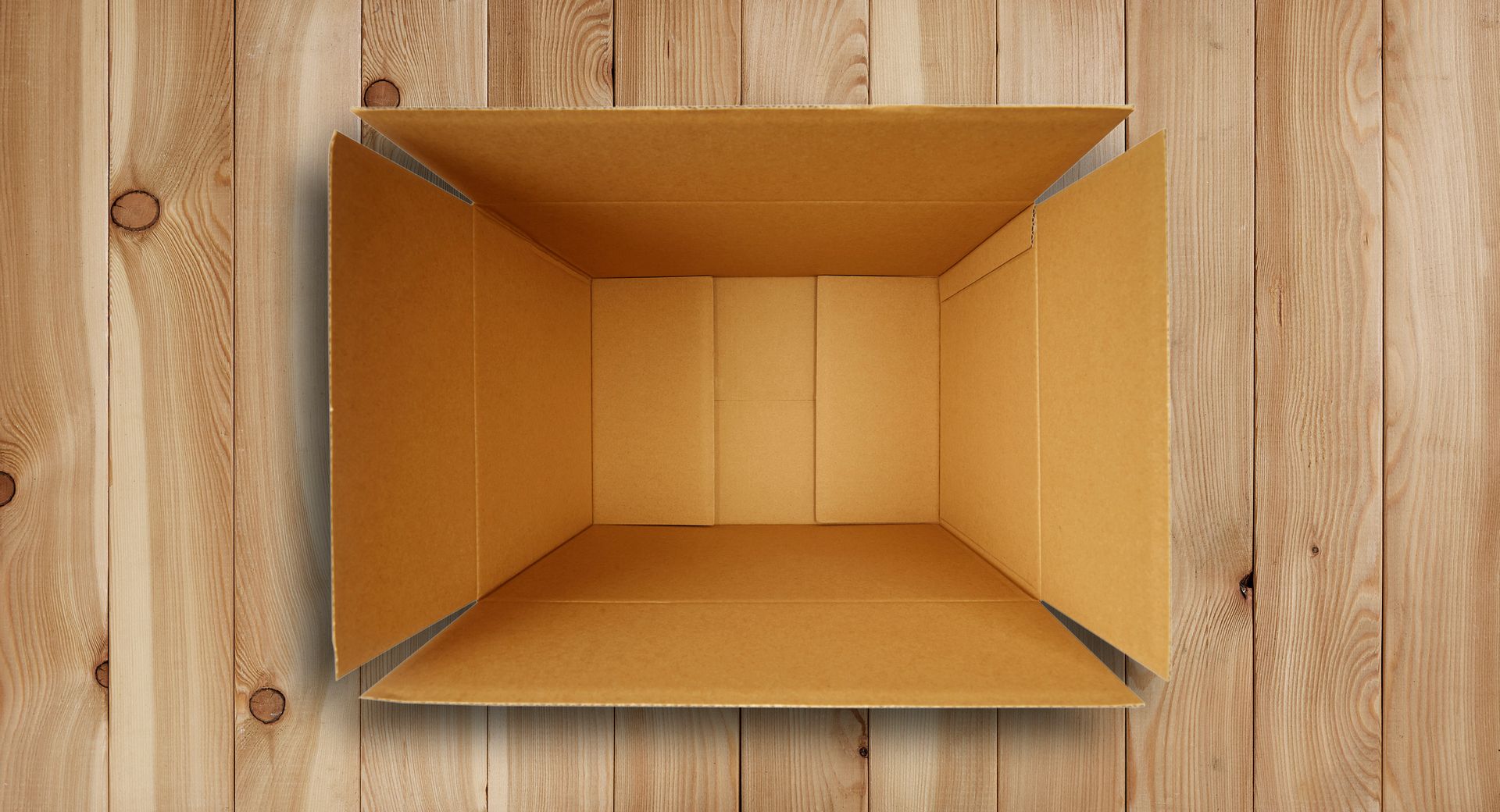 Open cardboard box on a woodgrain background.