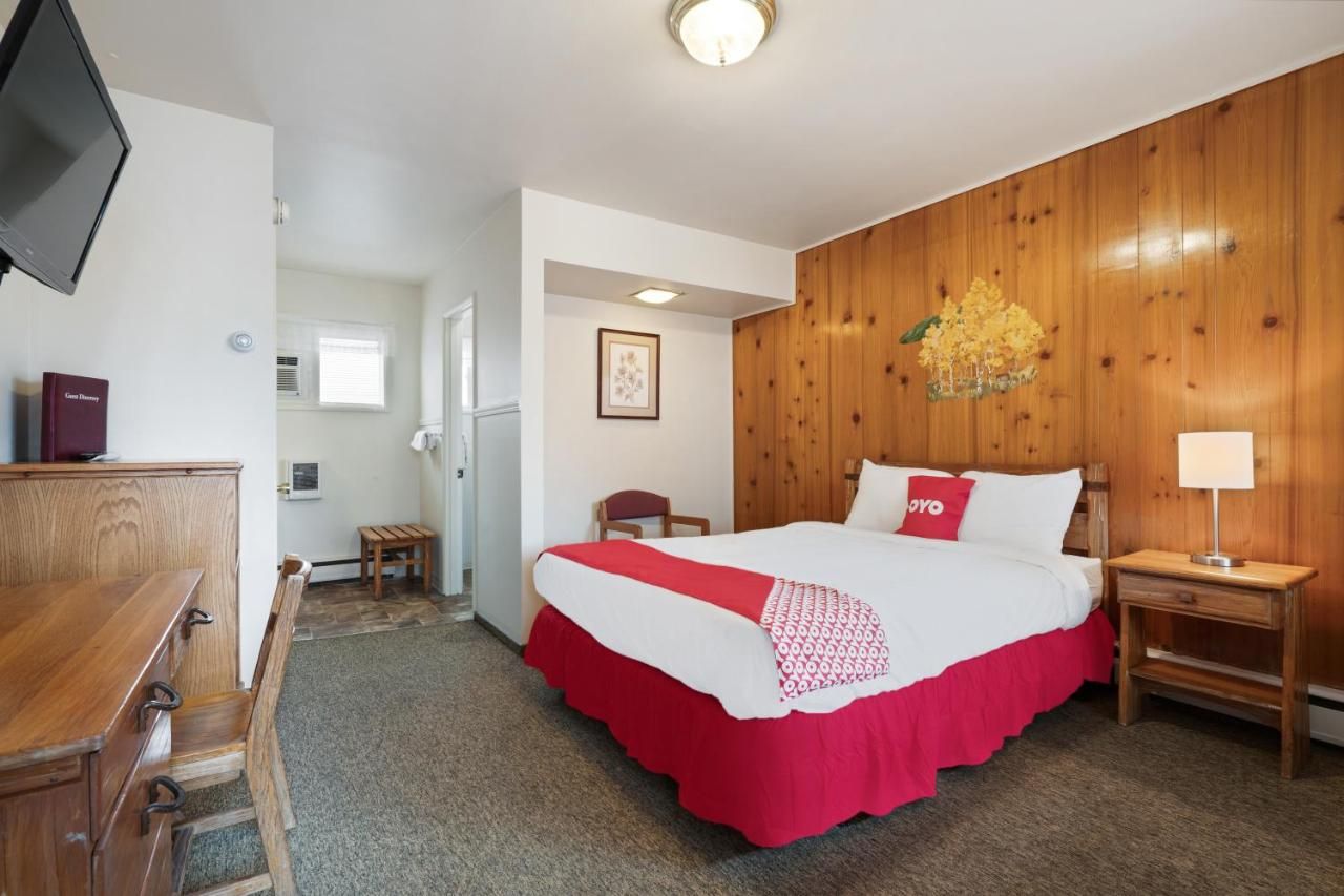 A hotel room with a bed and a television