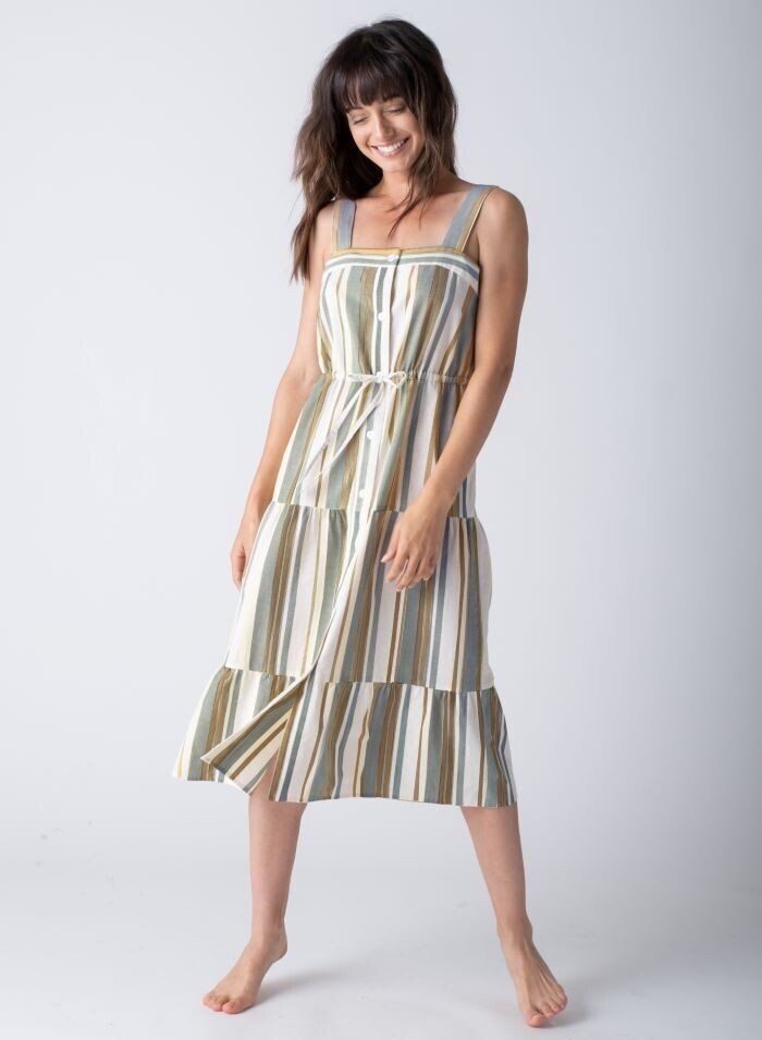 a woman is wearing a striped dress and smiling