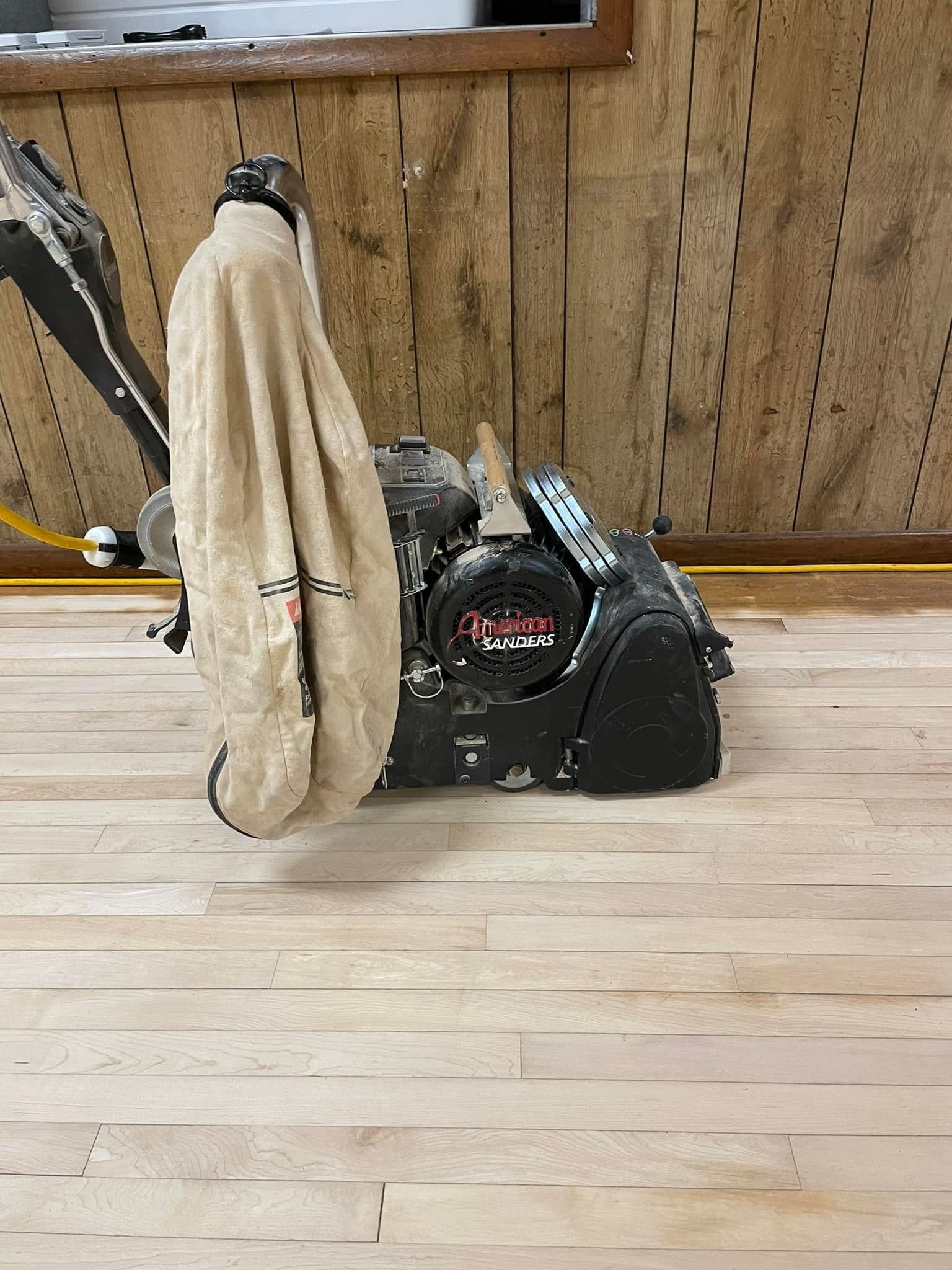 A machine is sitting on top of a wooden floor.