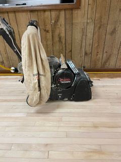 A machine is sitting on top of a wooden floor.