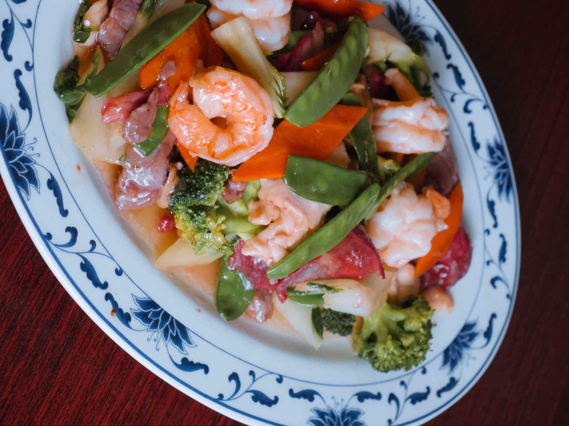 A plate of shrimp and vegetables on a table