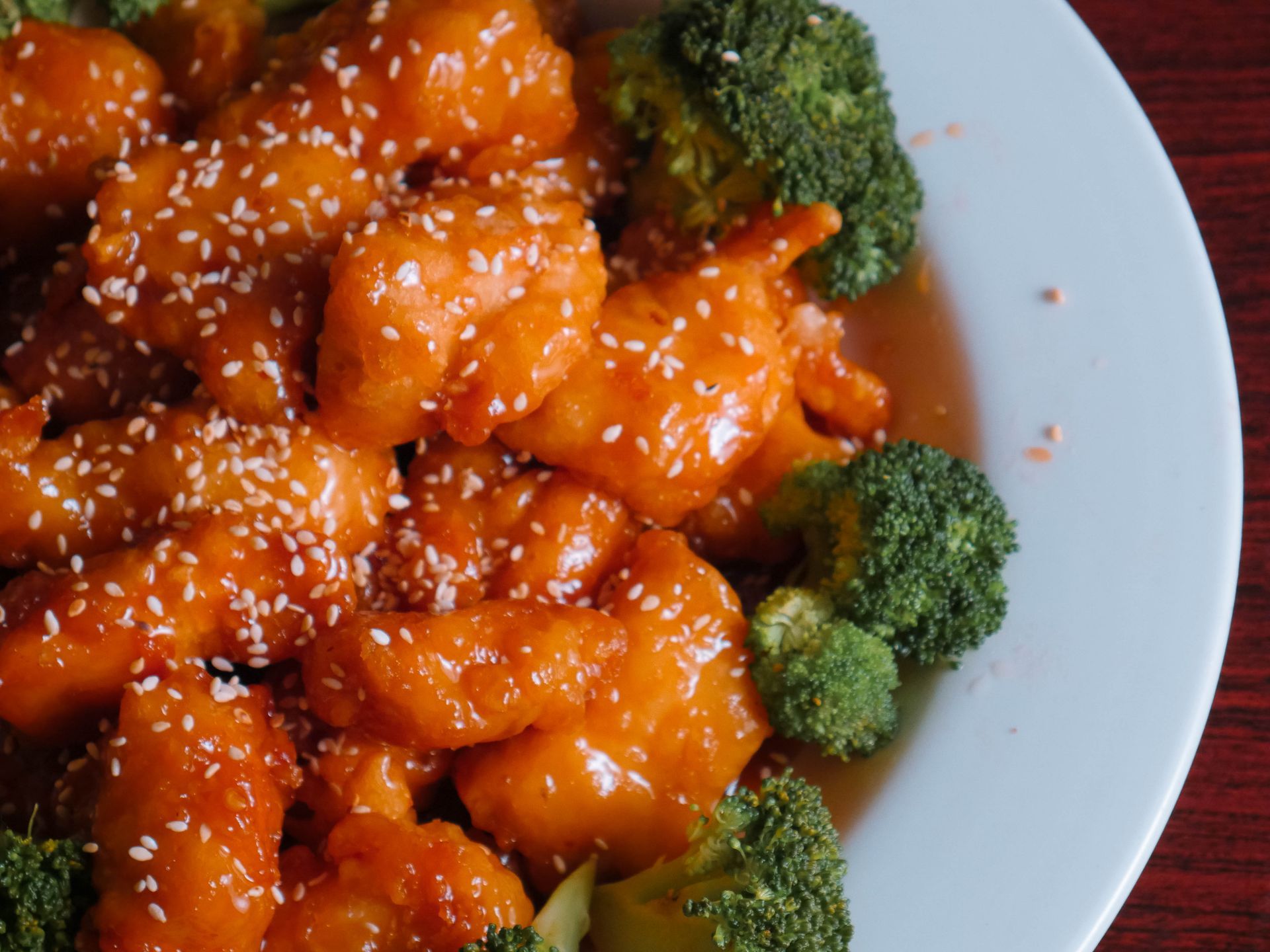 A close up of a plate of food with broccoli and shrimp