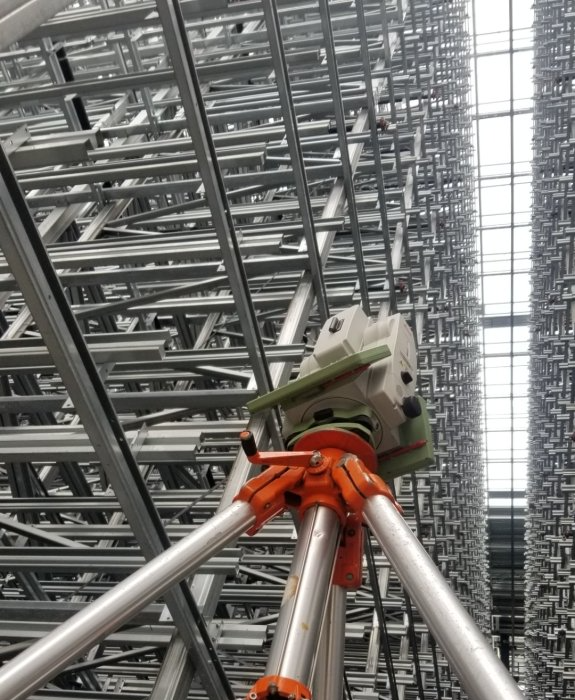 A very tall building with a tripod in the foreground