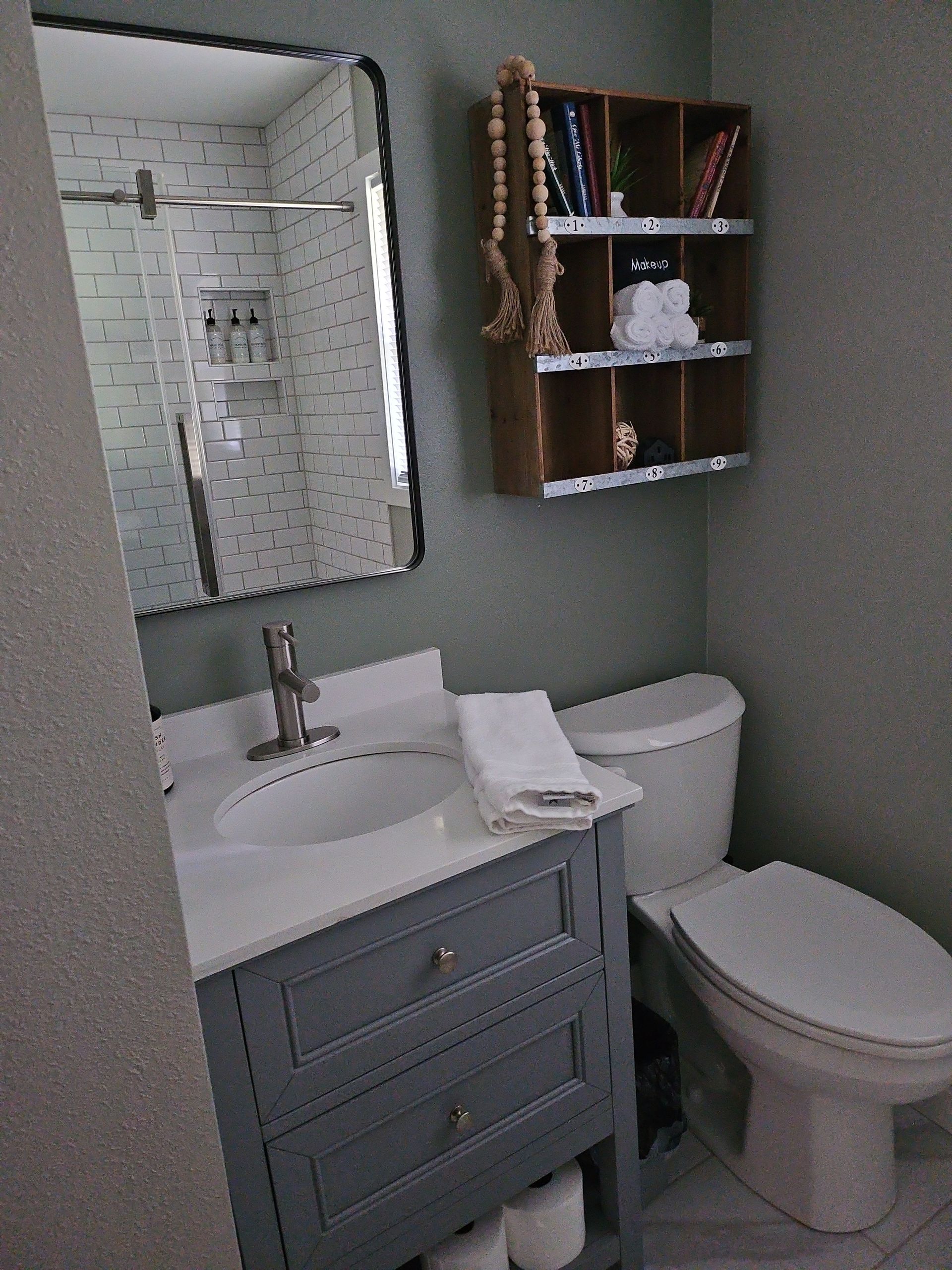 A bathroom with a sink , toilet and mirror
