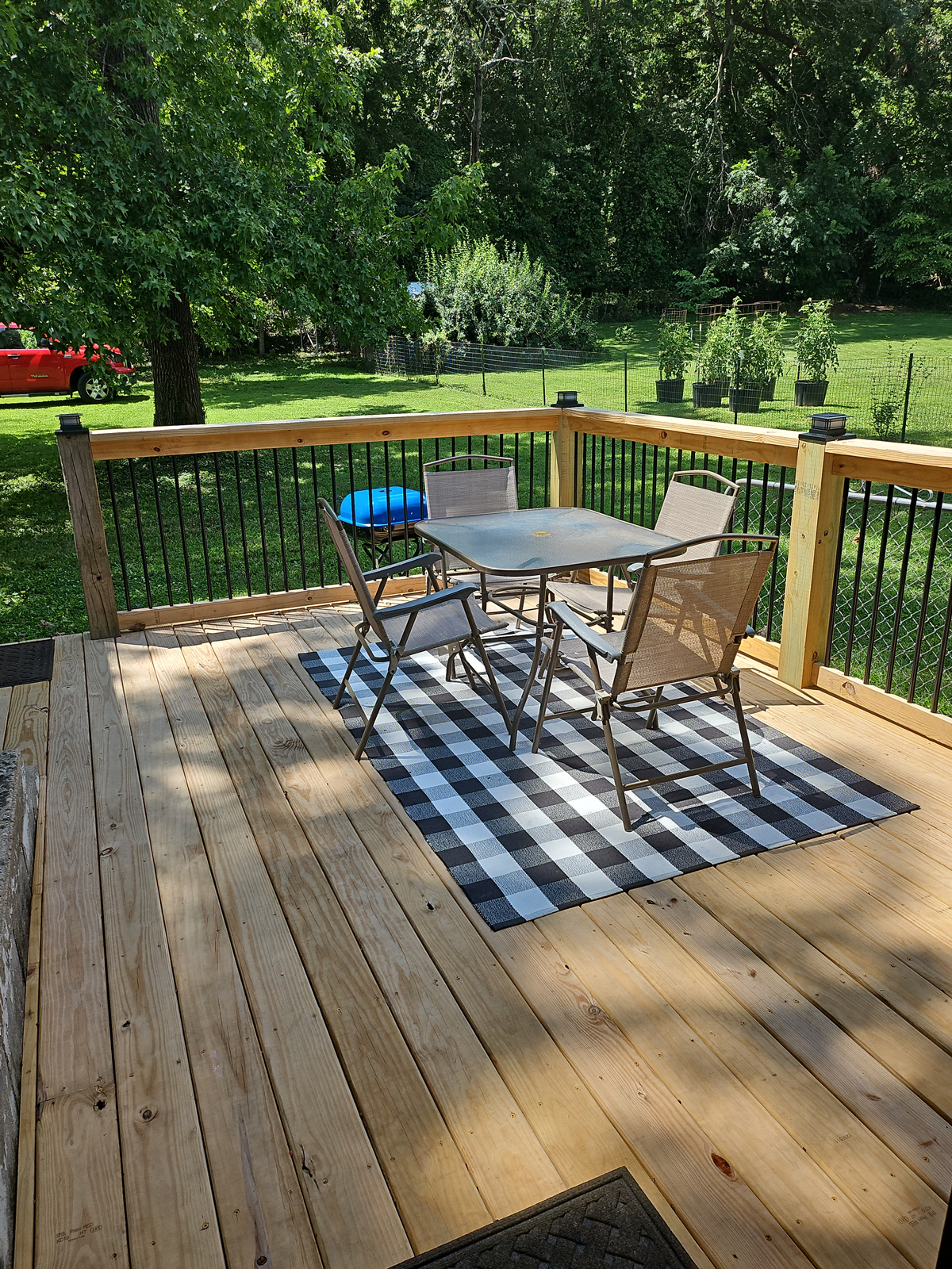 A wooden deck with a table and chairs on it.
