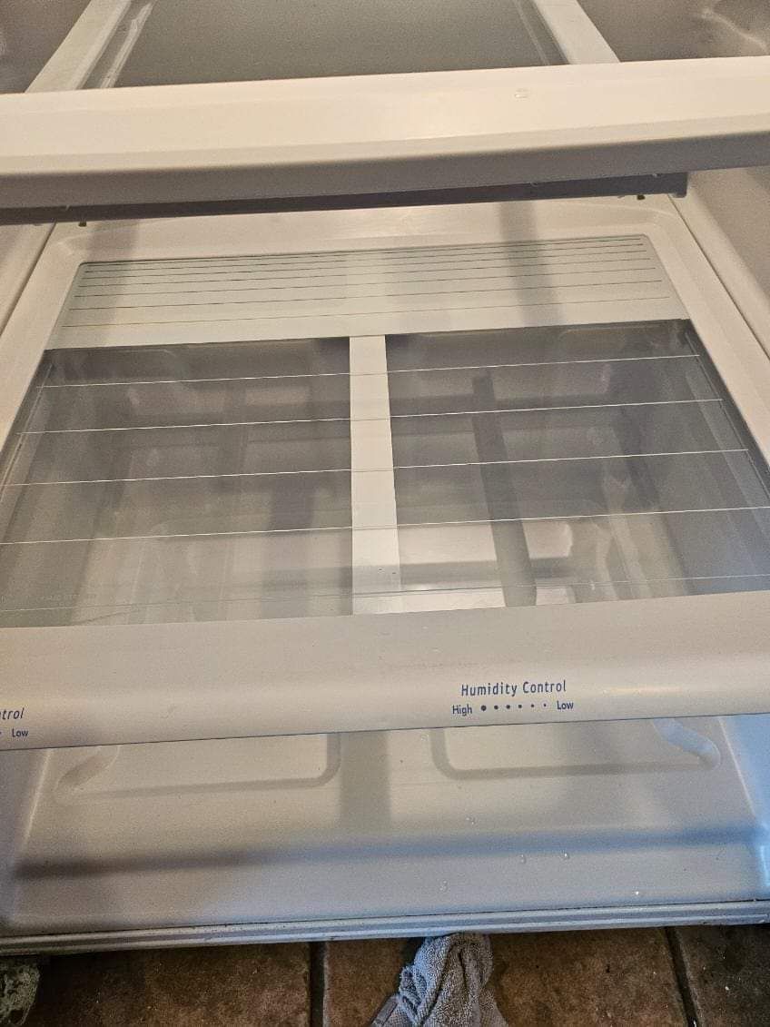 The inside of a refrigerator with a clear glass door.