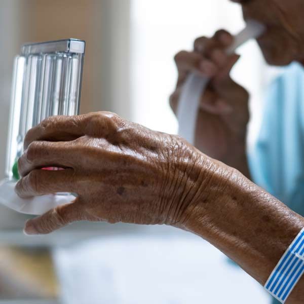 An elderly woman taking a breathing test representing Chronic Obstructive Pulmonary Disease (COPD) Treatments