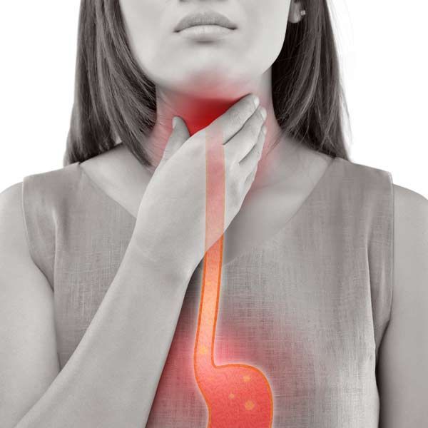 A woman is holding her throat because she has GERD needing GERD Treatments