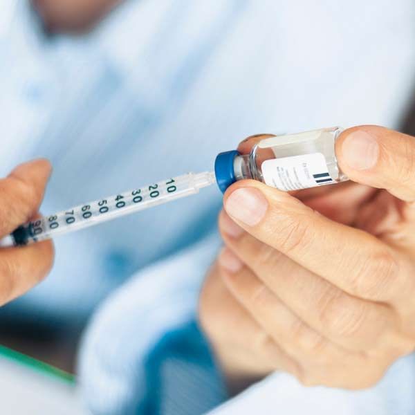 A person is holding a syringe of Personalized Semaglutide or Tirzepatide Medical Treatments for Weight Loss and Diabetes Management in Manhattan, NY and Connecticut
