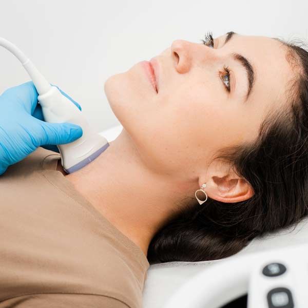 A woman is getting an ultrasound of her neck for Graves' Disease Treatments